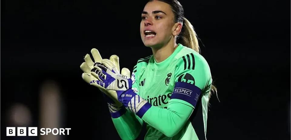 Goalkeeper in green kit directing teammates during match