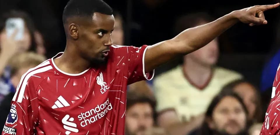 Player pointing during a match wearing Liverpool kit