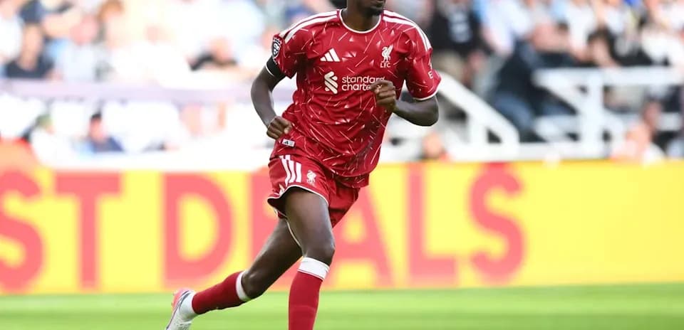 Player running on the field in red kit