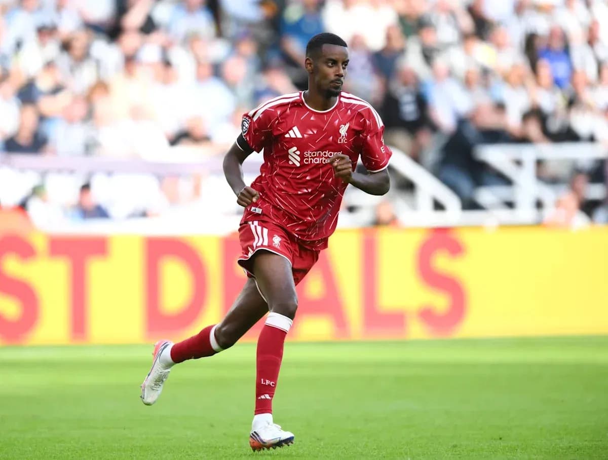 Player running on the field in red kit