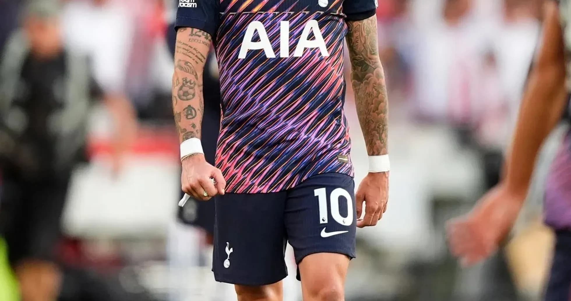 Player in Tottenham kit walking on pitch