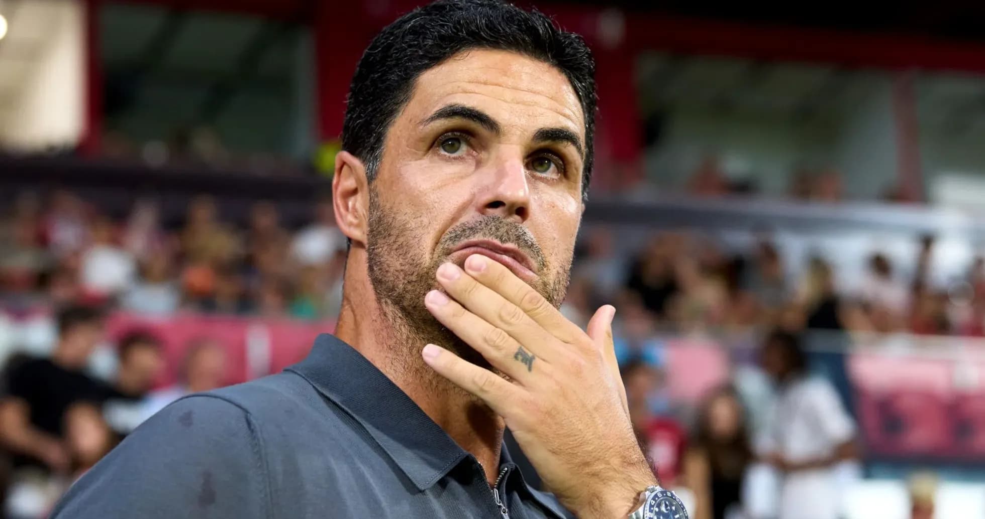 Manager contemplating during a match on sidelines