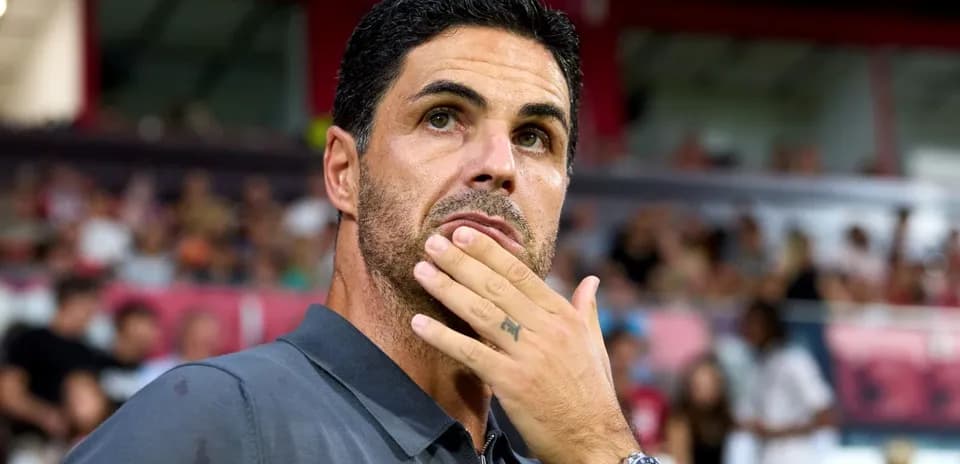 Manager contemplating during a match on sidelines