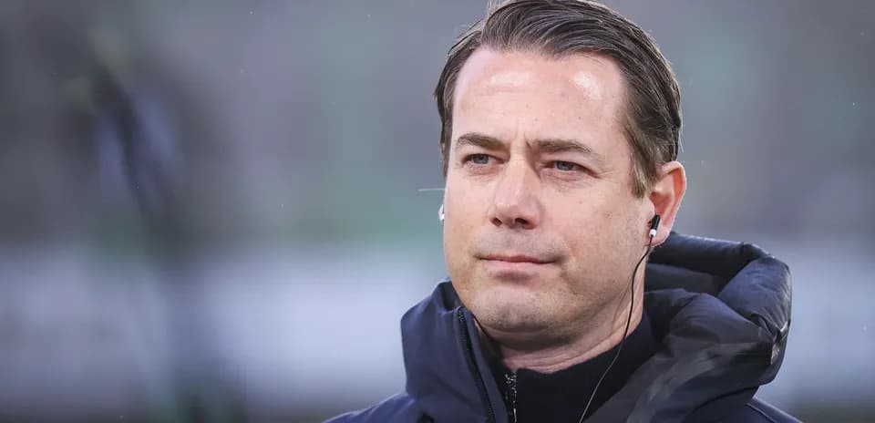 Coach wearing earpiece during match preparation
