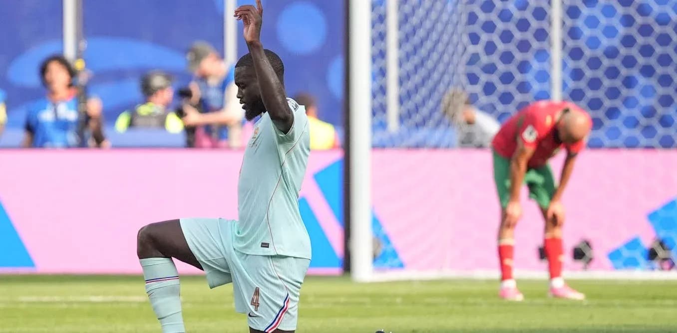 Player kneeling on field during football match