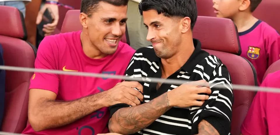Two football players chatting in stadium seats