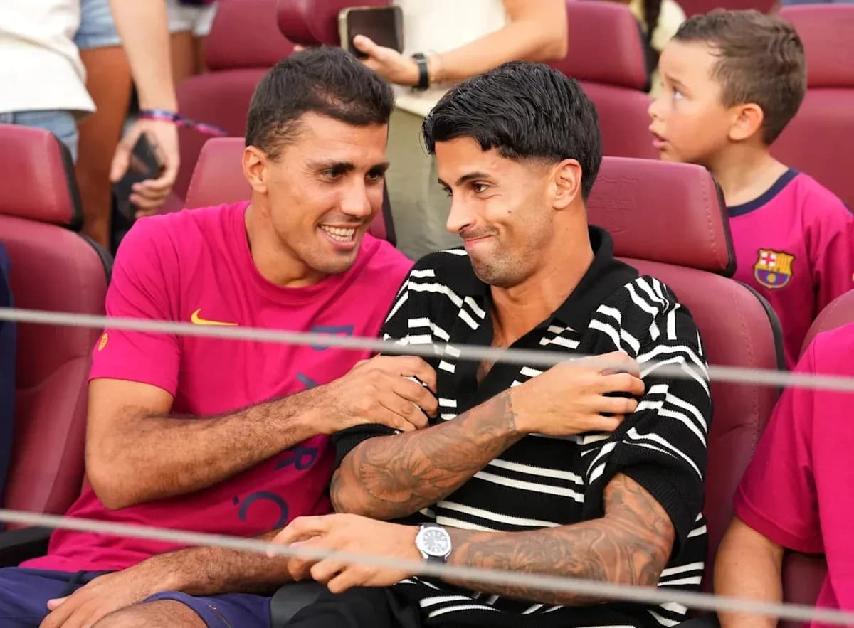 Two football players chatting in stadium seats