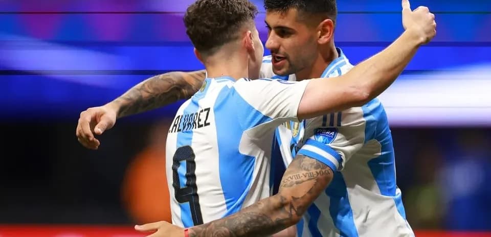 Two Argentina players celebrating a goal together