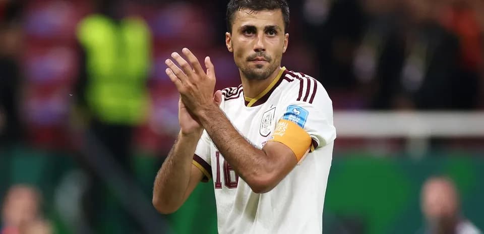 Player applauding fans wearing national team jersey