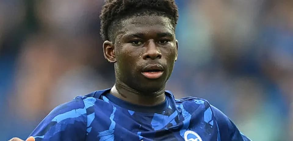 Player wearing Brighton kit during match action