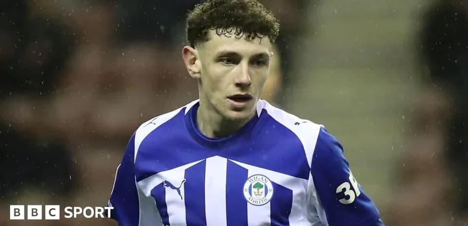Wigan Athletic player in blue and white kit
