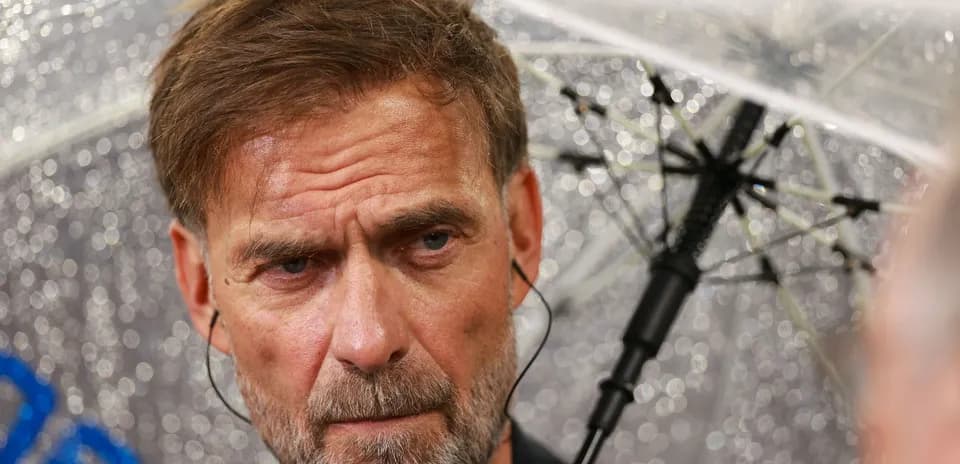 Man speaking under an umbrella during rain
