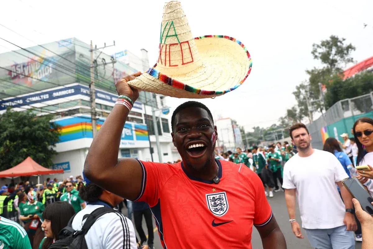 Fan wearing England jersey and sombrero at event