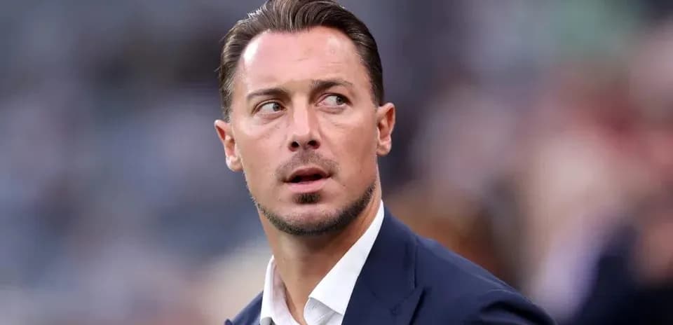 Man in suit looking away during a match