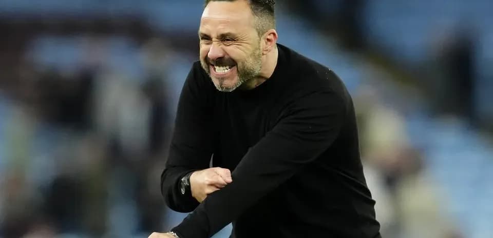 Coach celebrating enthusiastically on the sidelines
