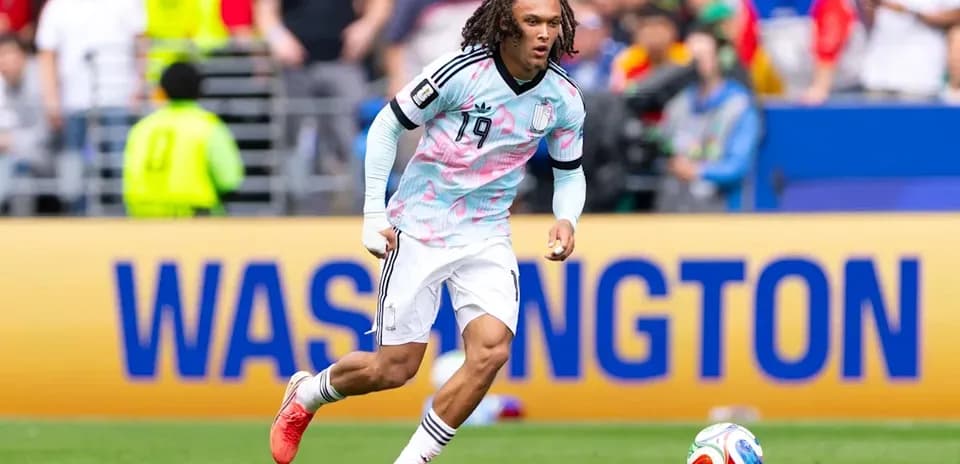 Player in colorful jersey running with soccer ball