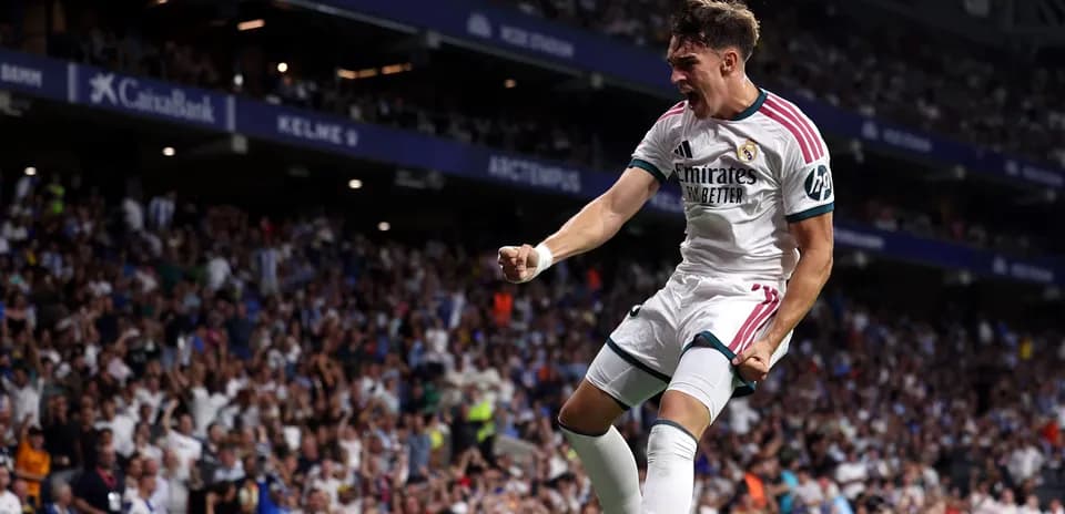 Player celebrating goal in front of cheering crowd