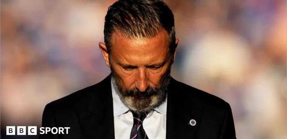 Man in suit looking down, possibly in thought