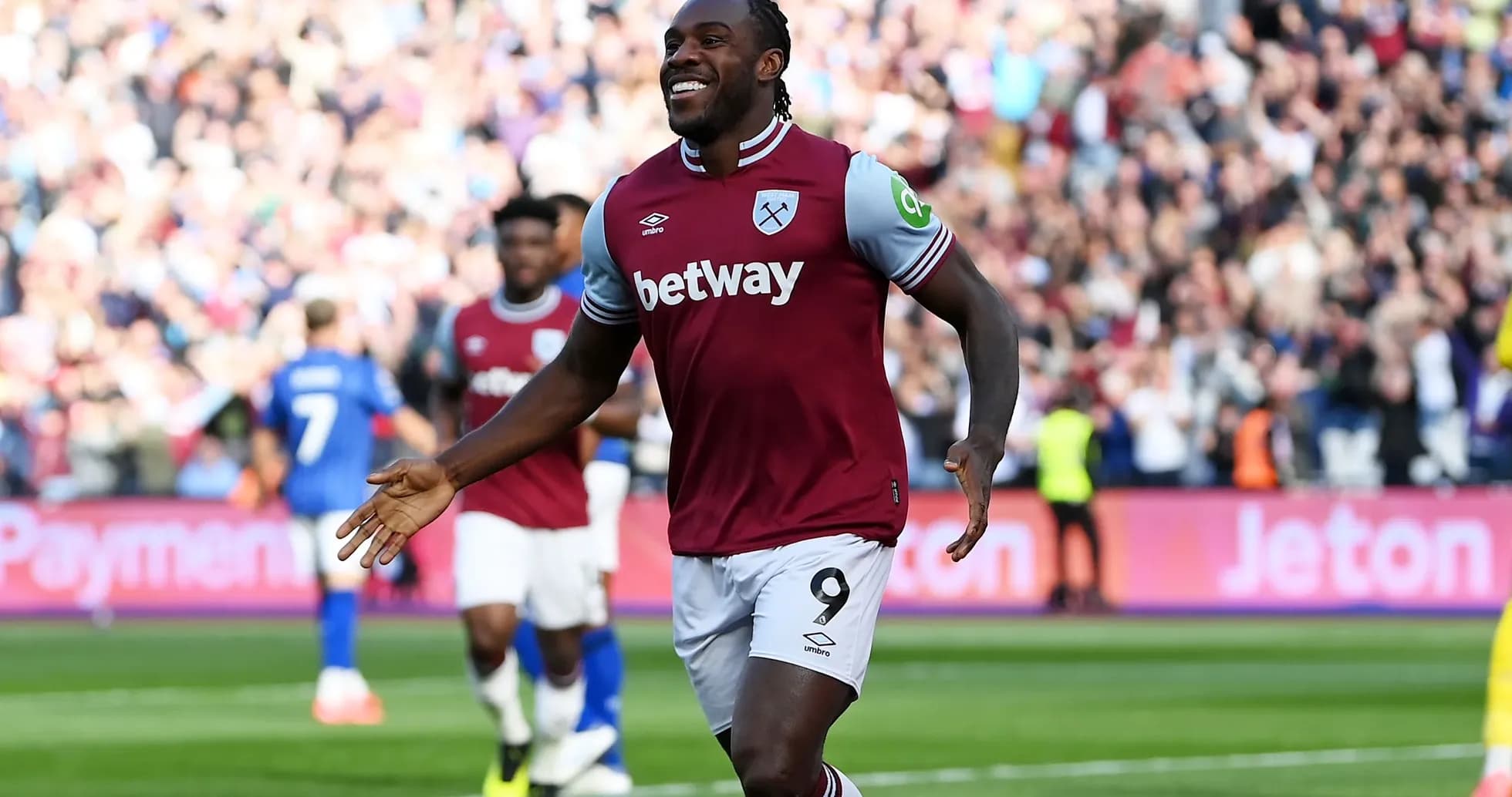 Player celebrating a goal at a stadium