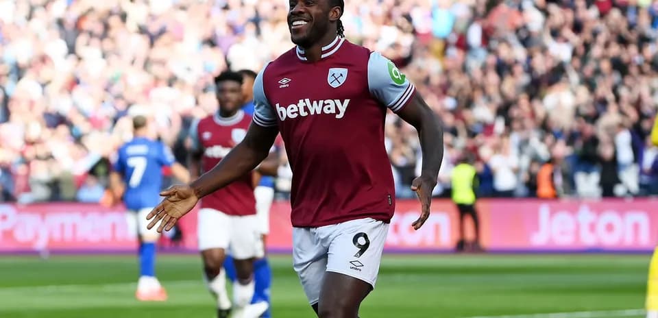 Player celebrating a goal at a stadium