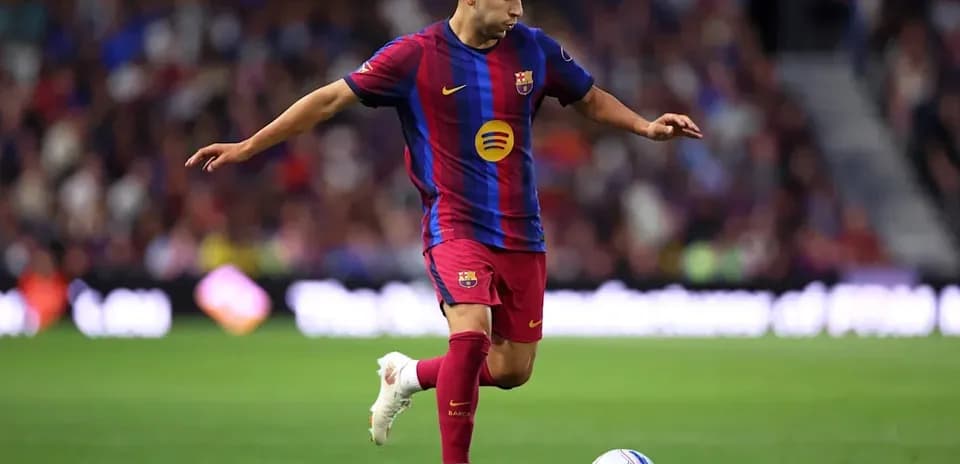 Player in Barcelona kit controlling the ball on field