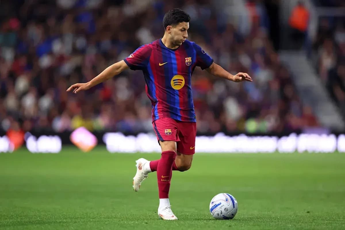 Player in Barcelona kit controlling the ball on field