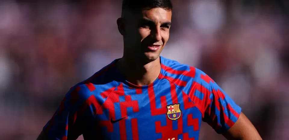 Player posing in Barcelona jersey with sponsor logo