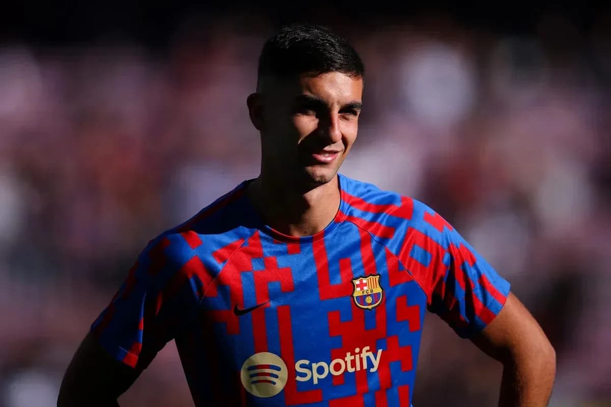 Player posing in Barcelona jersey with sponsor logo