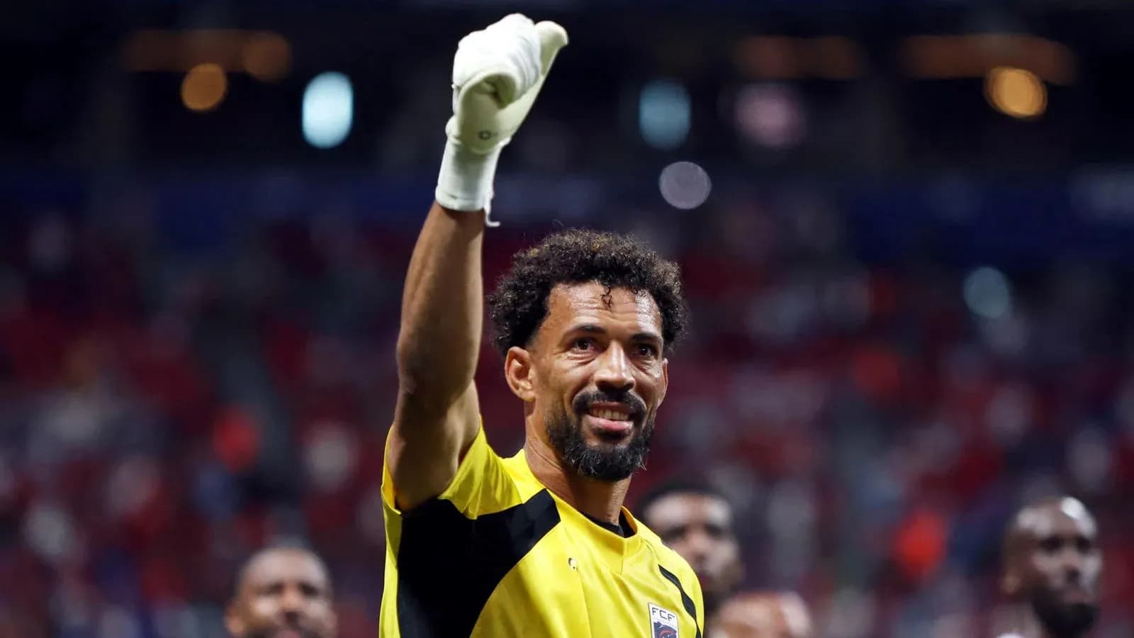 Goalkeeper celebrating with raised hand after match