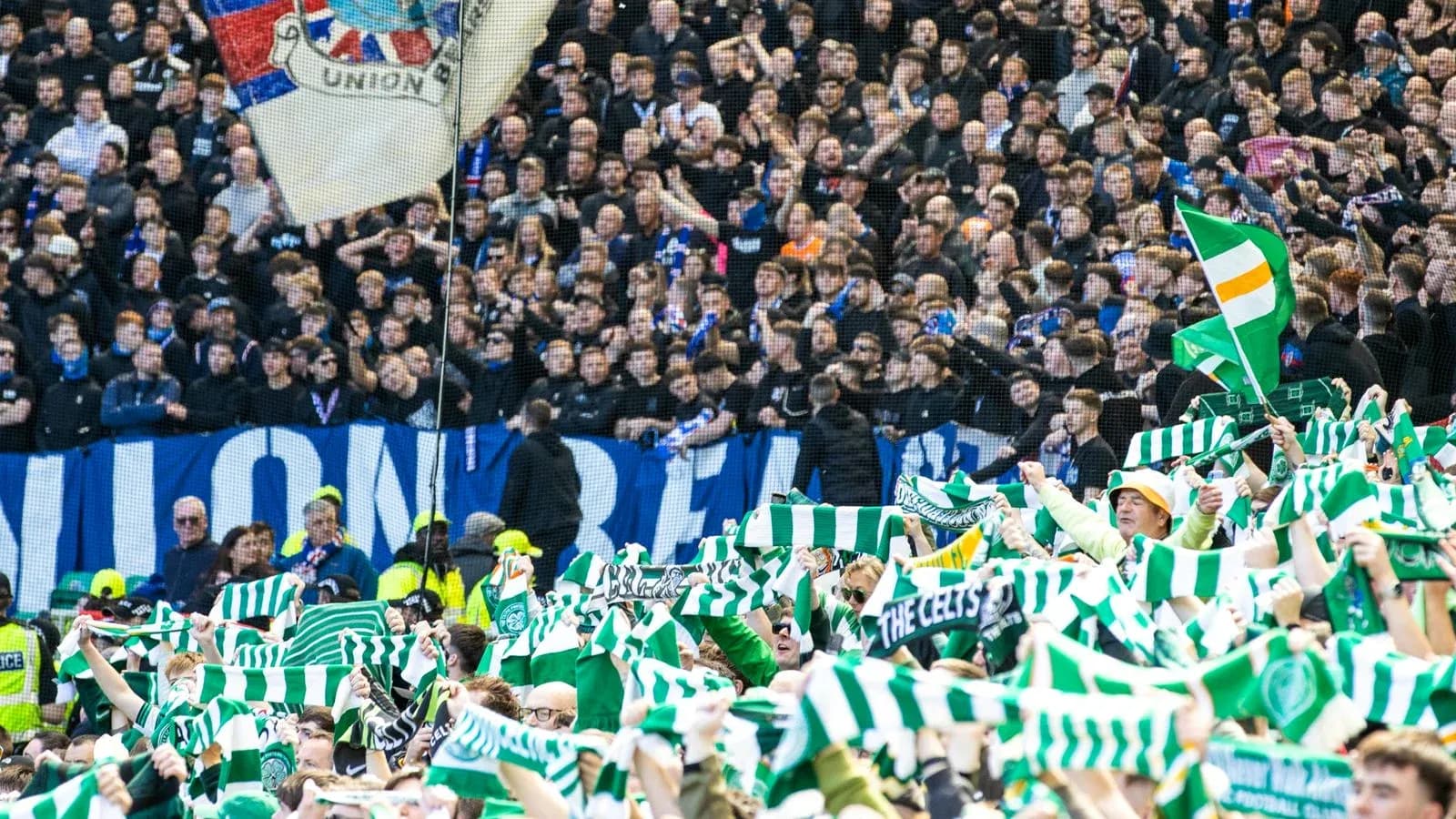 Celtic fans waving scarves during a match