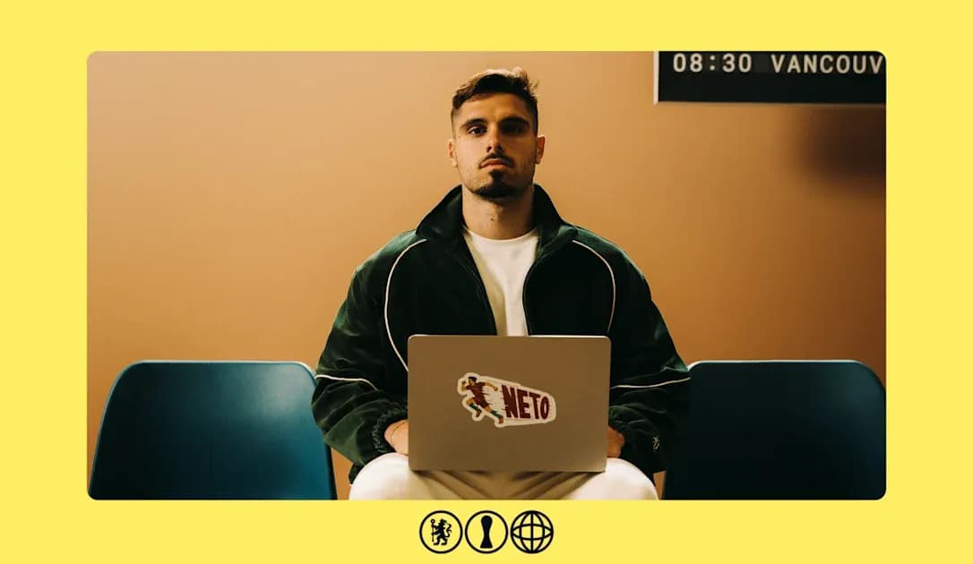 Man sitting with laptop displaying 'NETO' sticker