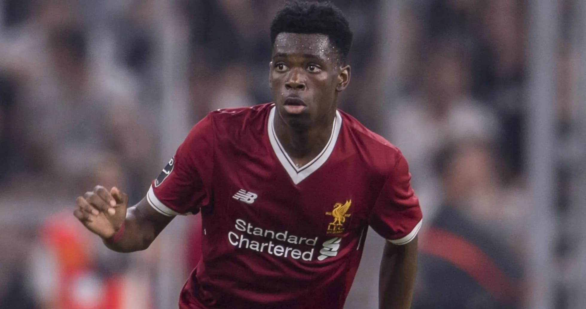 Player in Liverpool kit running during match
