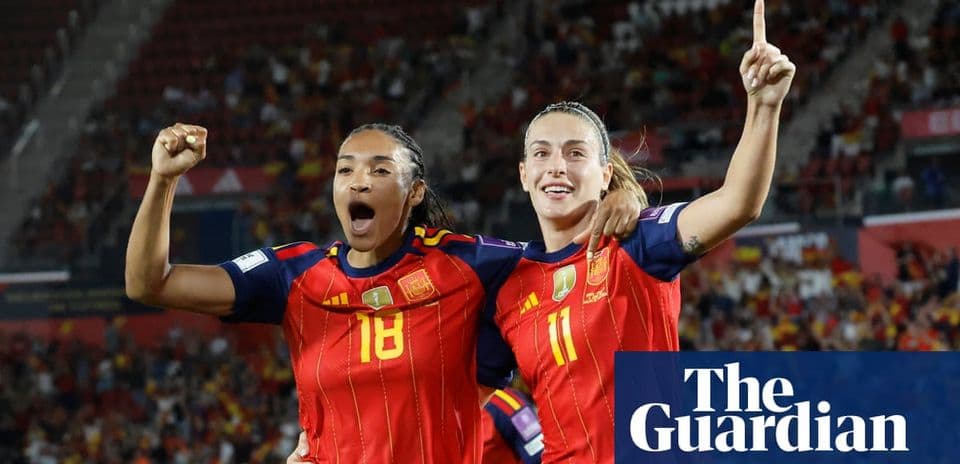 Two Spanish players celebrating a goal together