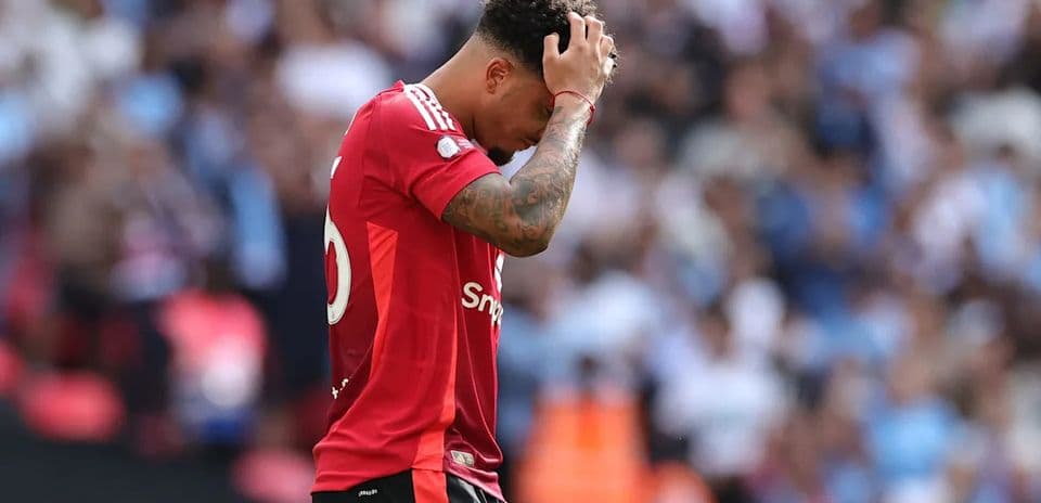 Player in red jersey looking down on the field