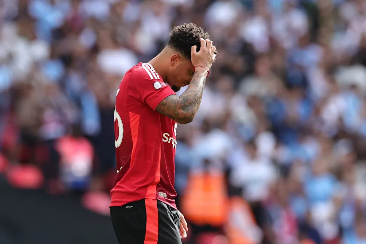 Player in red jersey looking down on the field
