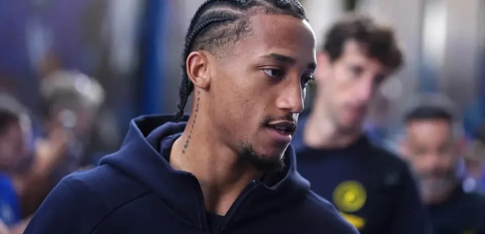 Player with braids walking in team attire