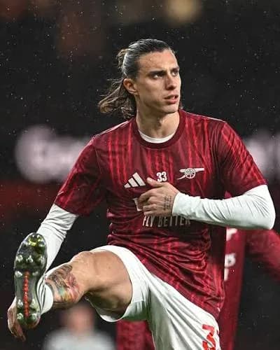 Player stretching during warm-up in red kit