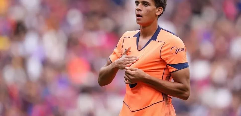 Player gesturing during match in orange jersey