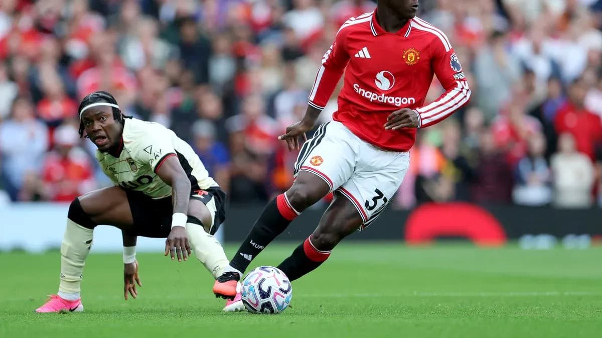 Manchester United player dribbling past opposing player