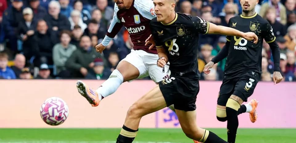 Aston Villa player striking the ball against Burnley