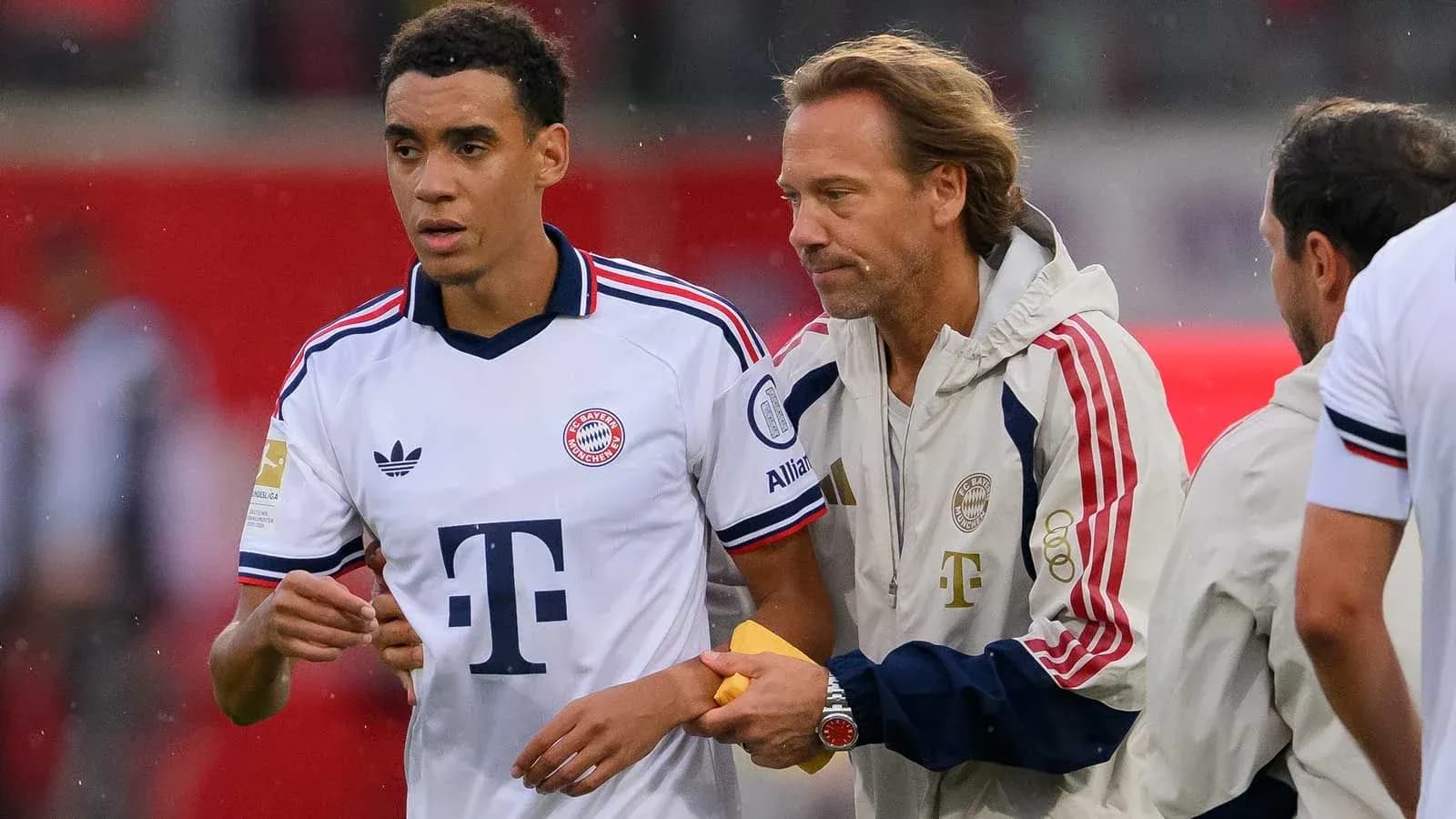 Bayern Munich player receiving instructions from coach