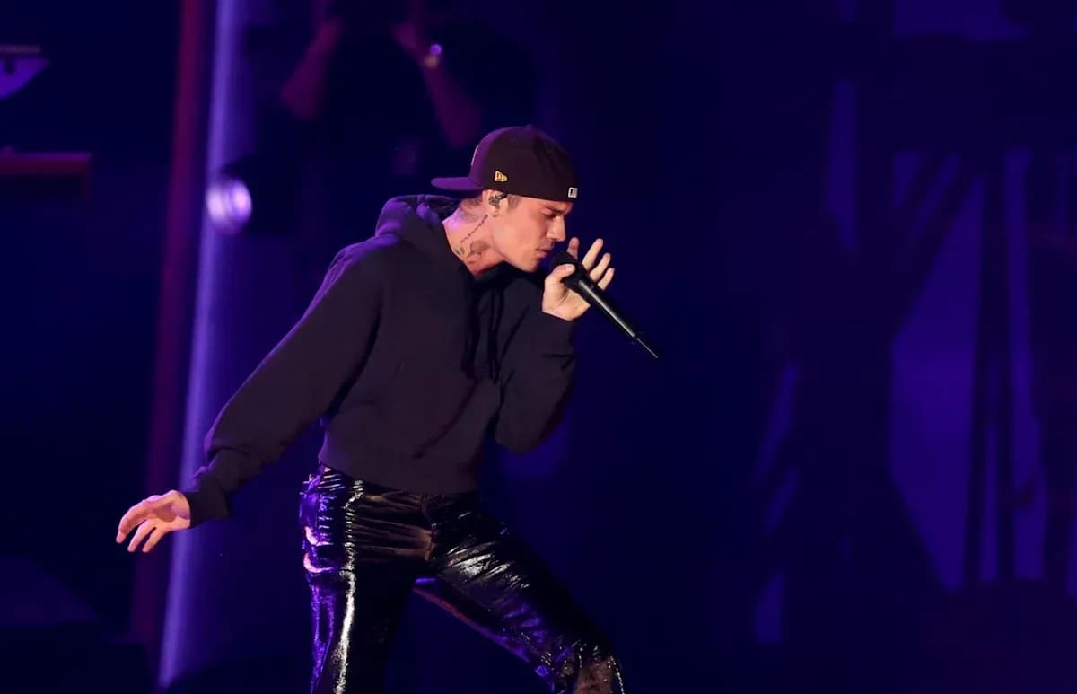 Performer singing into microphone on stage
