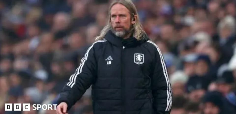 Manager in black coat directing team from sidelines