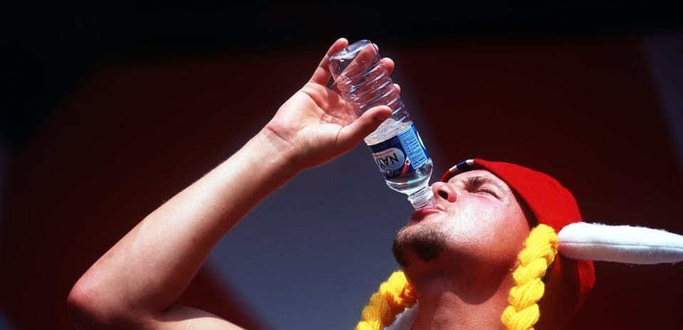 Person drinking water during a sports event