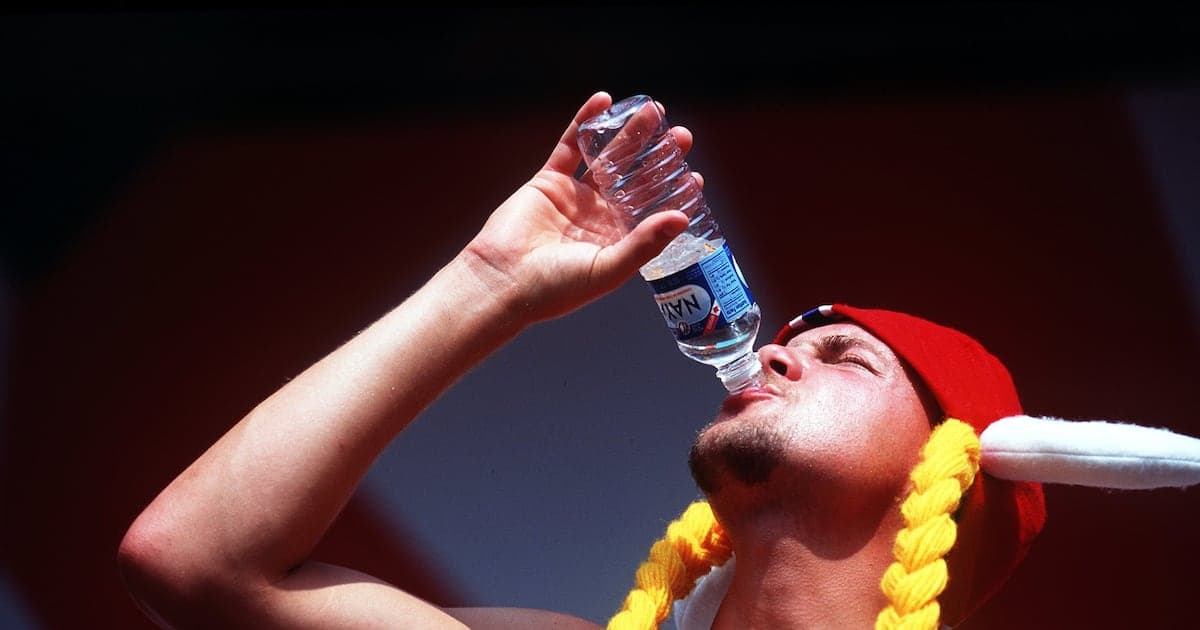 Person drinking water during a sports event