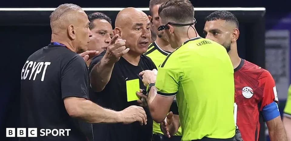 Referee discussing with Egyptian team officials during match