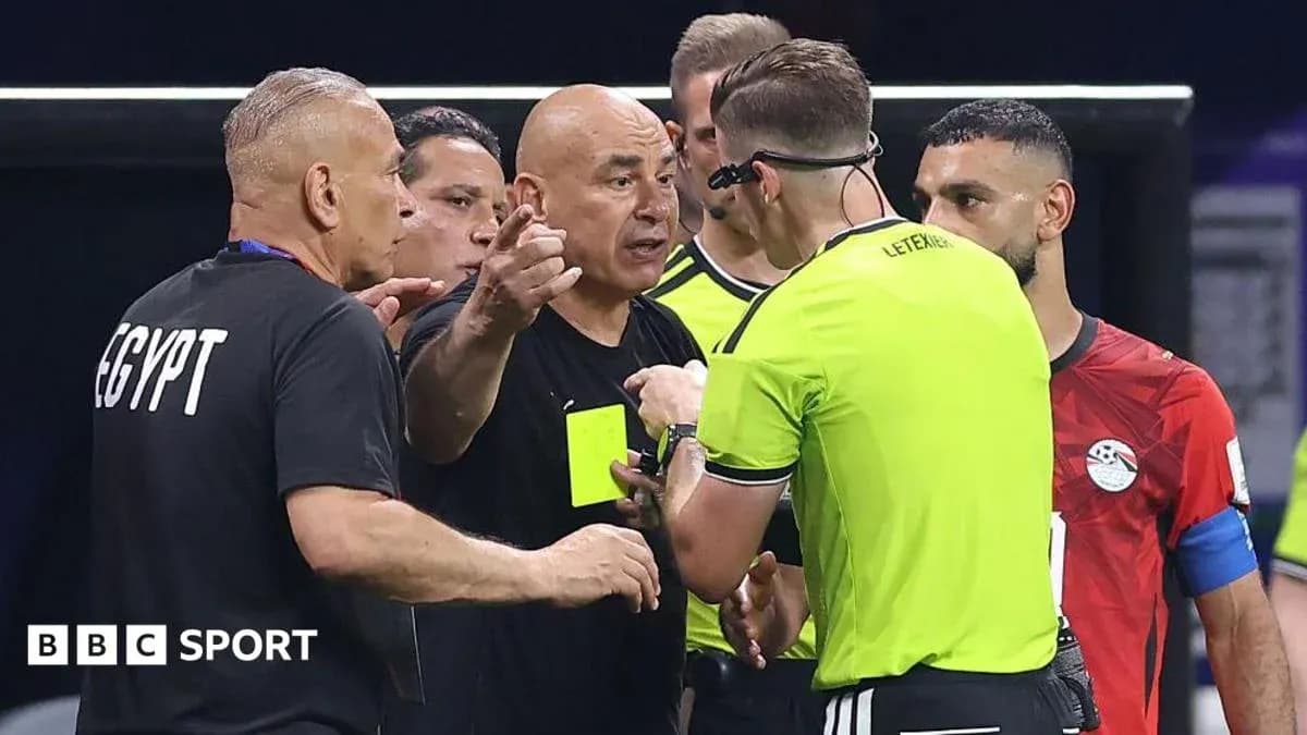 Referee discussing with Egyptian team officials during match