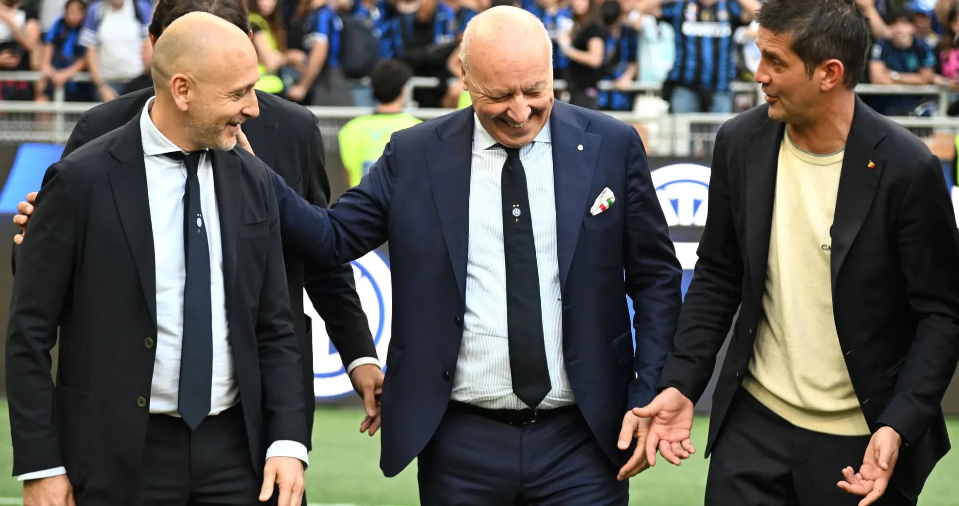 Coaches interacting on the field before a match