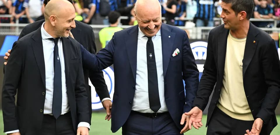 Coaches interacting on the field before a match
