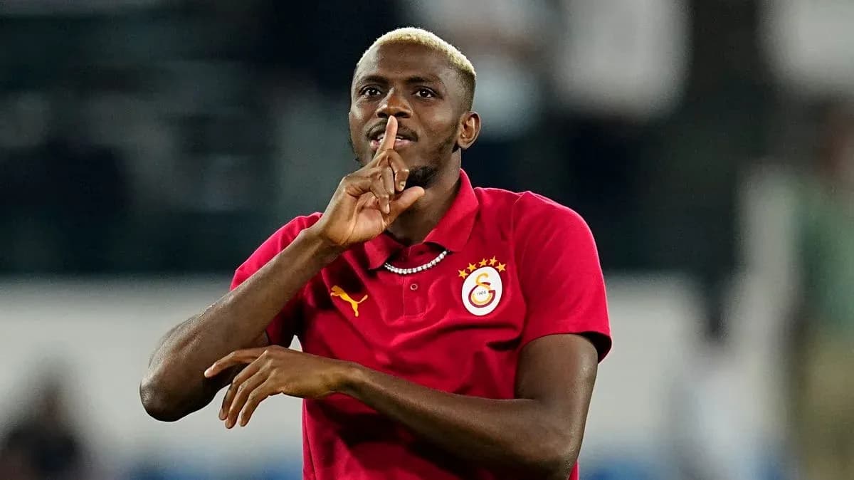 Player making shushing gesture during match celebration